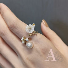 Load and play video in Gallery viewer, Anthia Jewelry Cherry Blossom Gold Flower and Fresh Water Pearl Adjustable Silver Ring
